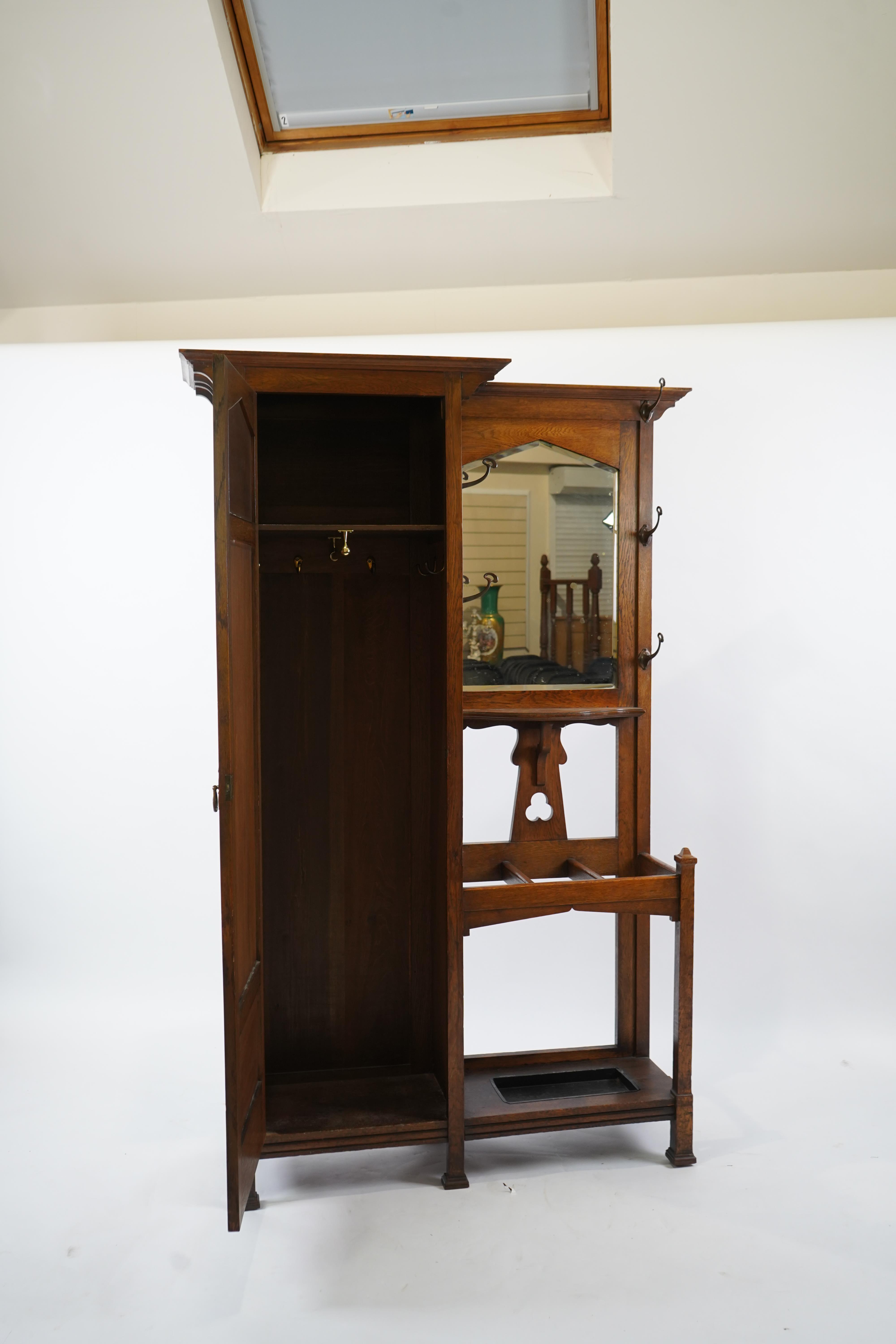Manner of Liberty & Co: An Arts and Crafts embossed copper mounted oak hall cupboard